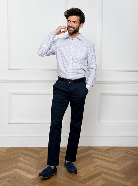 Man wearing long sleeved shirt in a tattersall blue check pattern design with premium and luxury cotton in Thomas Mason fabric.